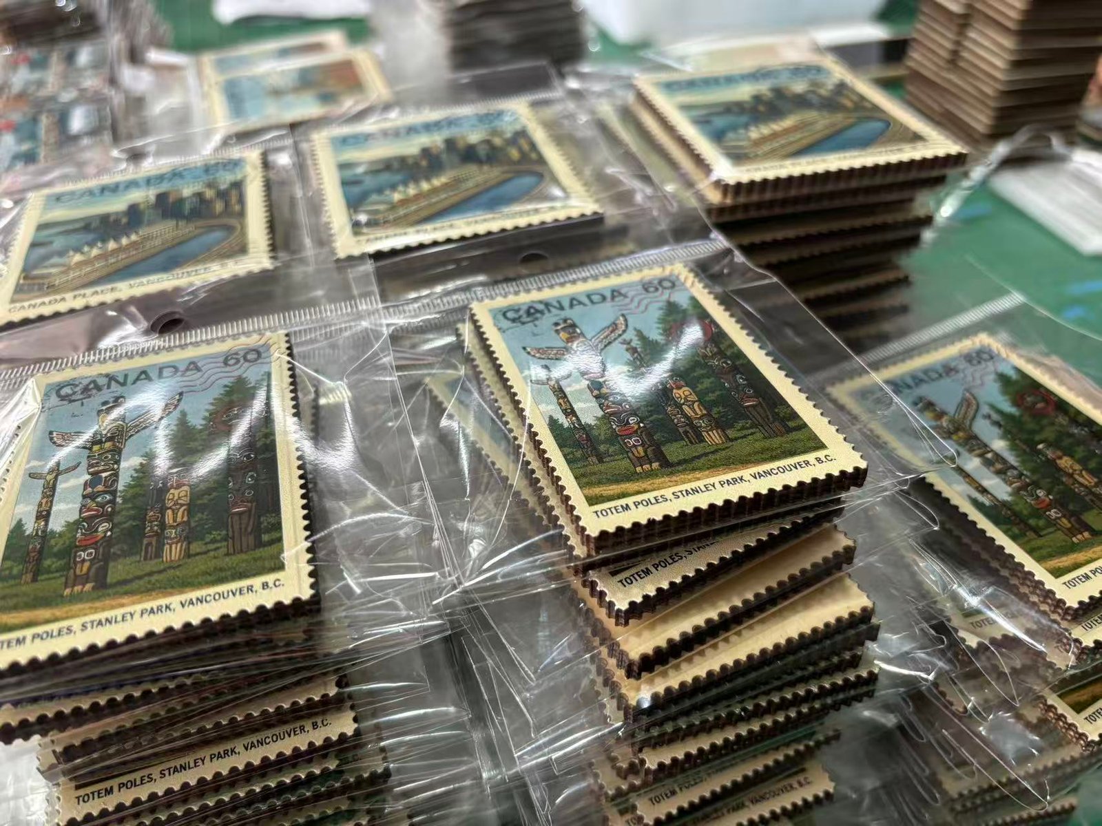 Stack of finished custom stamp magnets with OPP packaging ready for retail