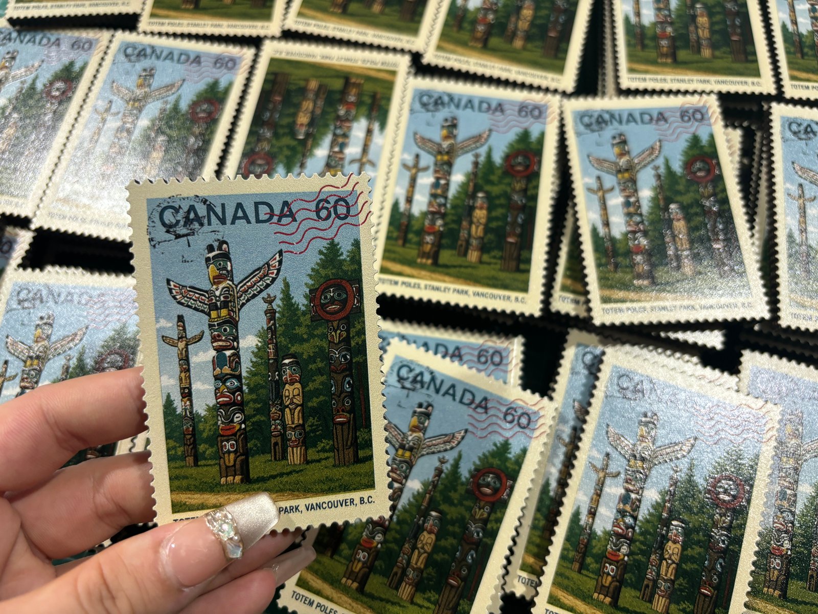 Close-up of custom stamp magnet showing full-color UV print quality and serrated edge