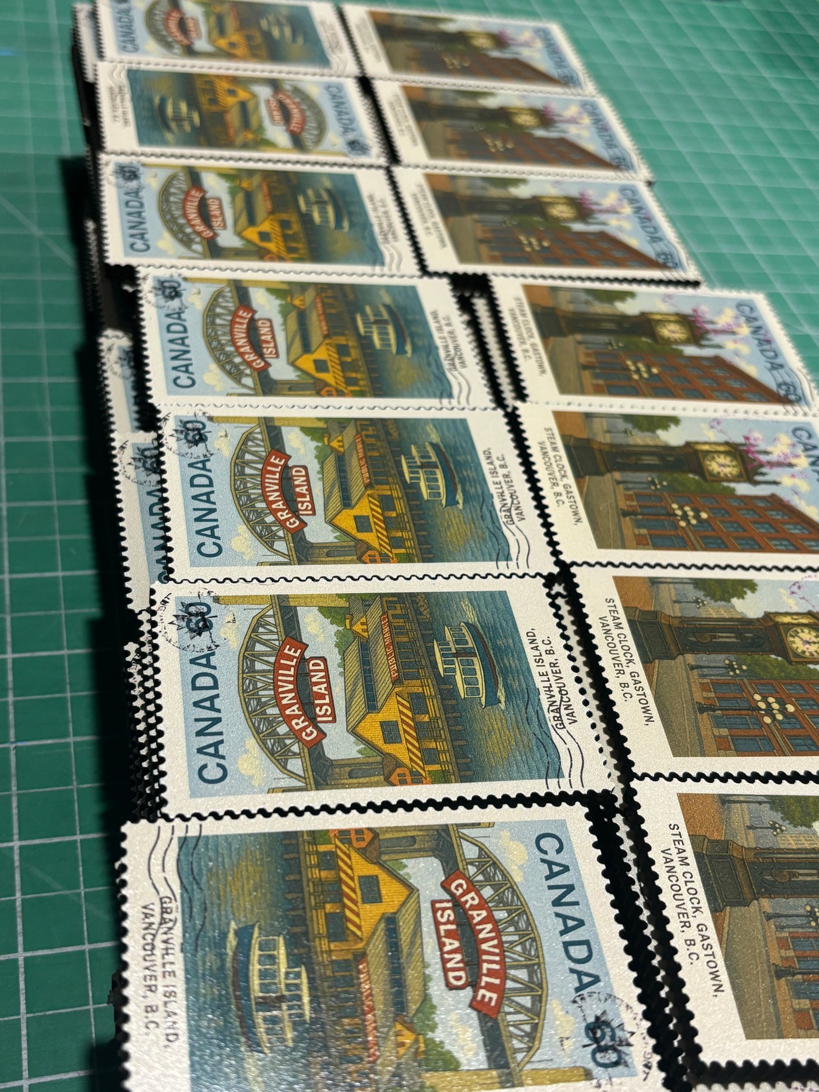 Custom stamp souvenir magnets stacked showing production volume and serrated edge detail