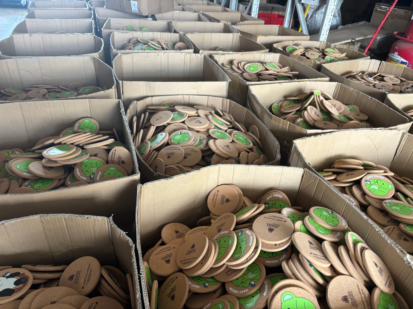 Bulk cartons filled with finished custom cork coasters ready for packaging