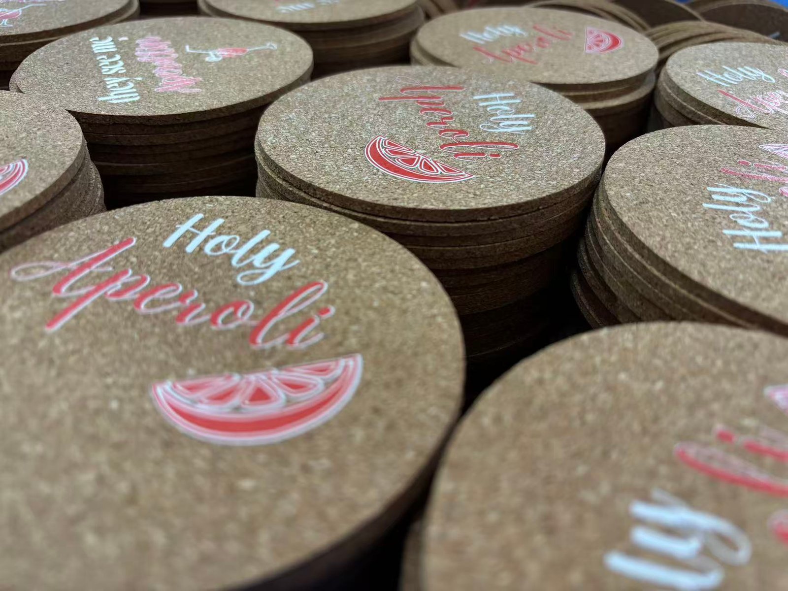 Factory floor showing bulk cork coaster production and quality control