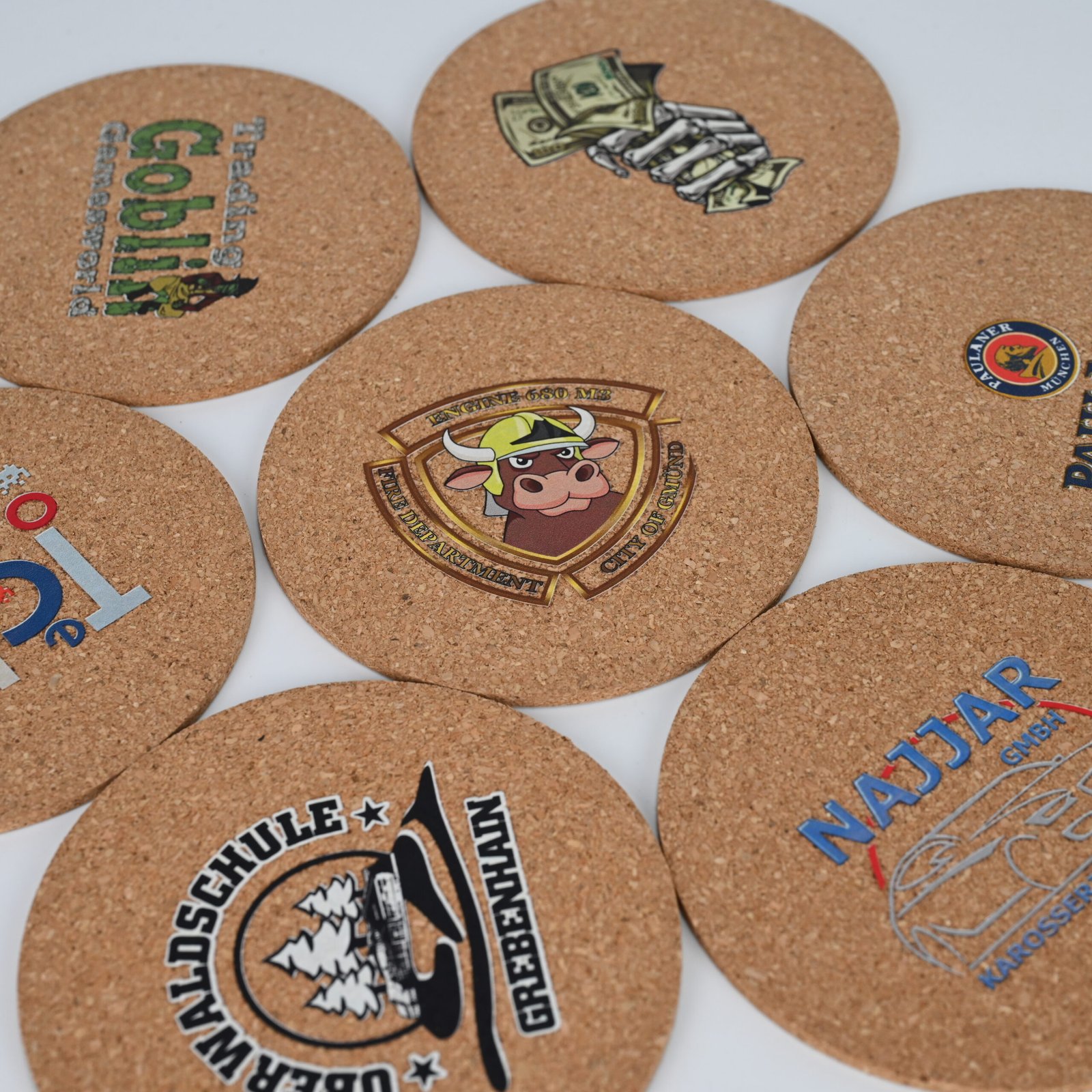 Custom printed 3mm cork coasters in round and square format showing various client designs