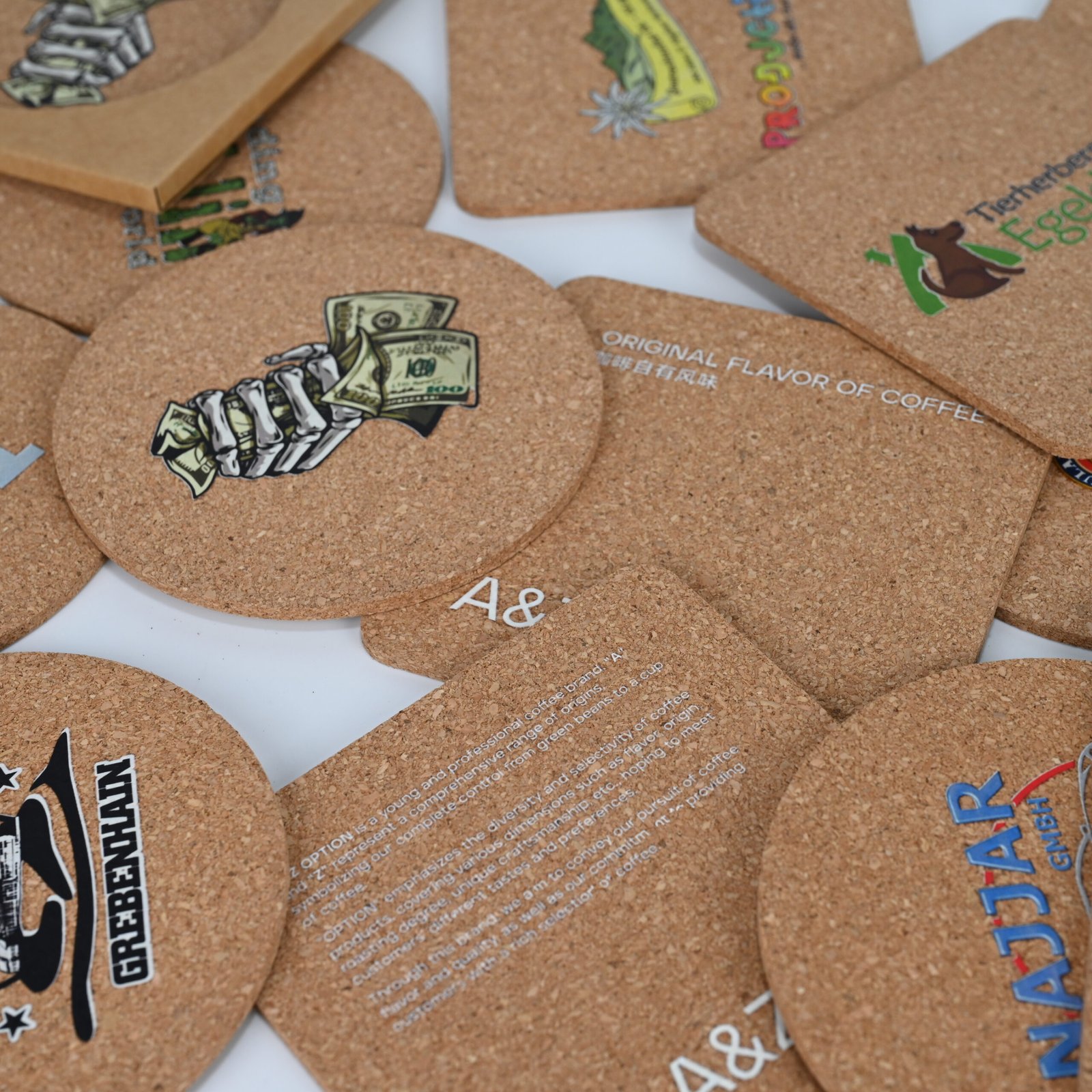 Hand holding square cork coaster sideways clearly showing slim 3mm thickness