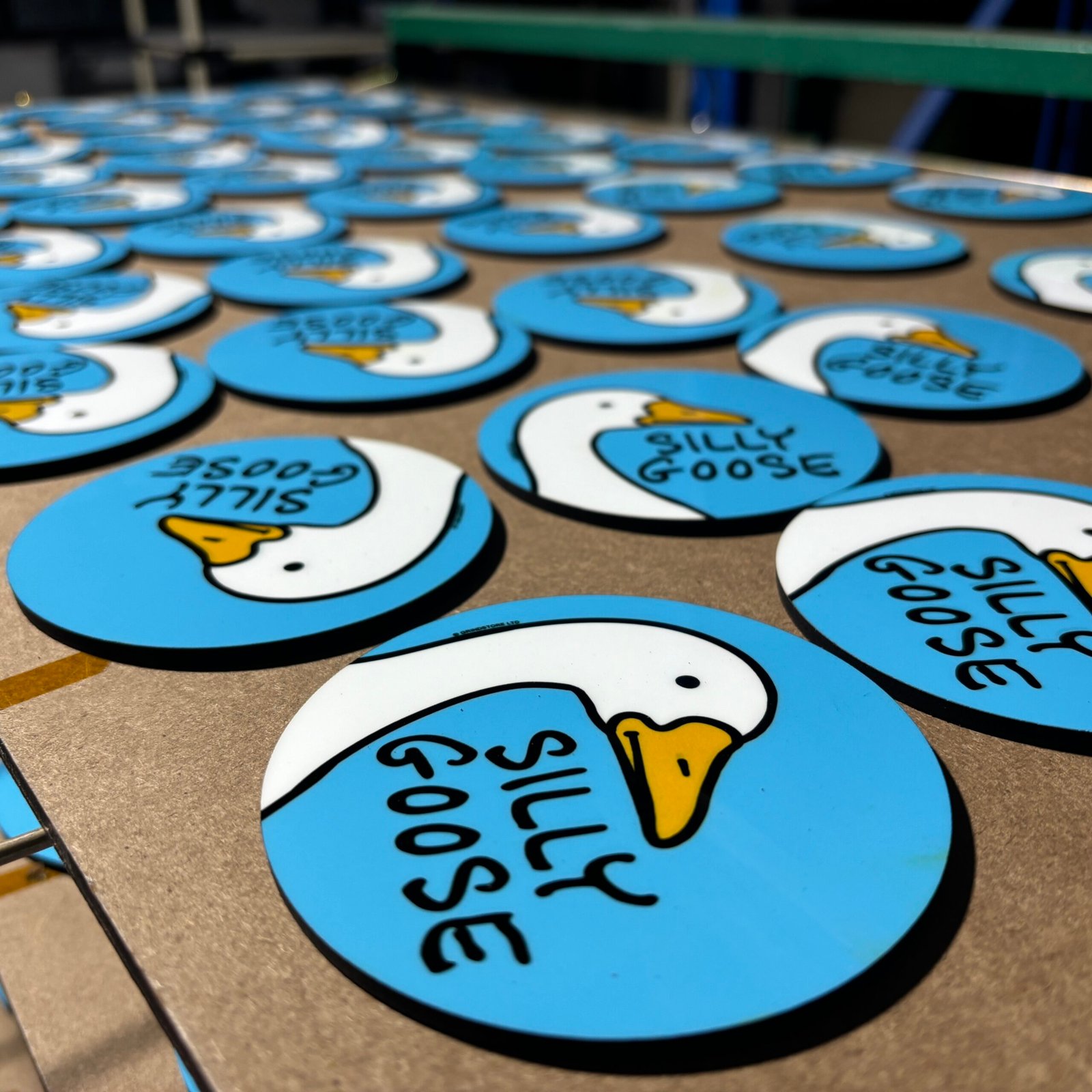 MDF coasters on production drying rack showing factory scale