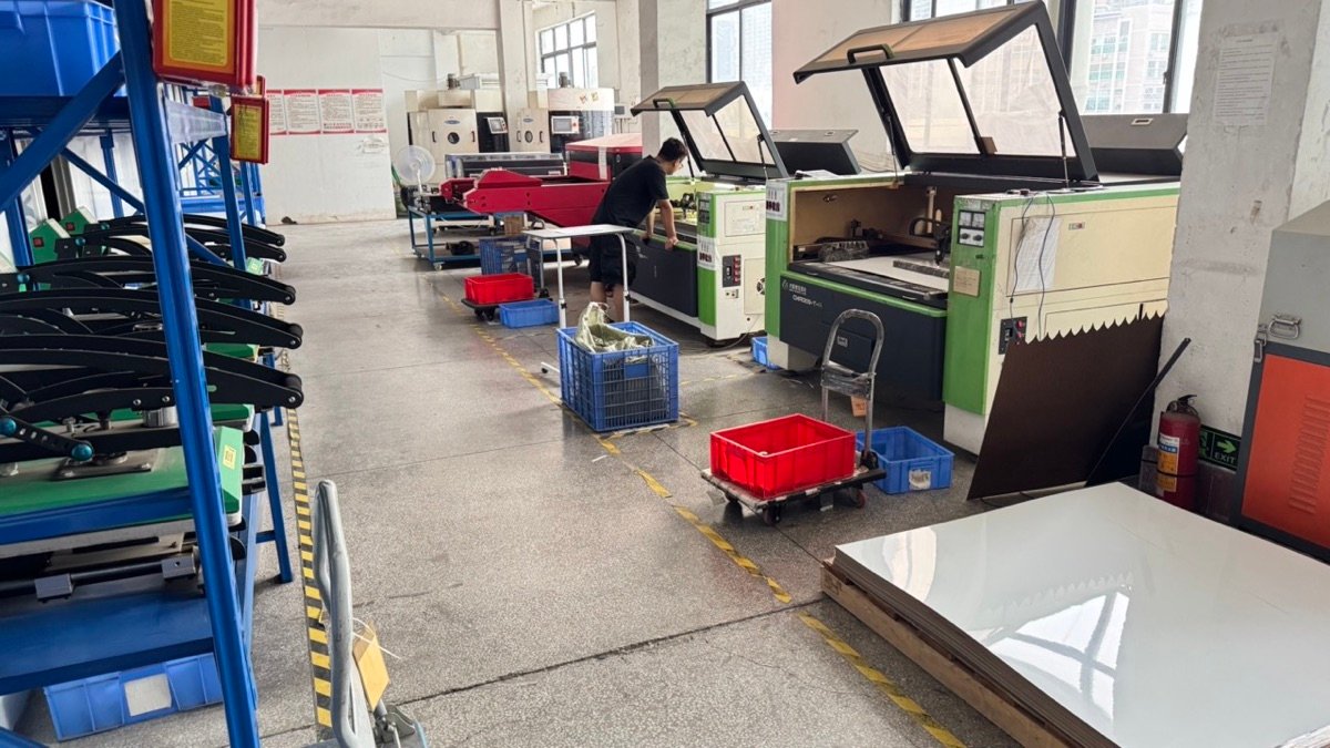 Customento main production floor with laser cutting machines and staff at work
